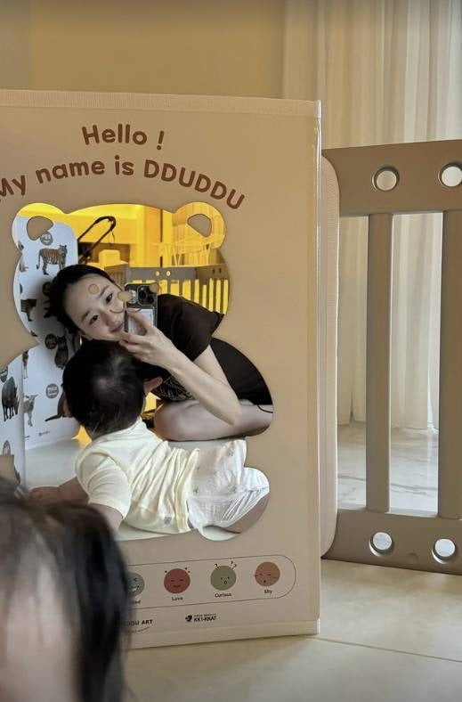 Former rhythmic gymnast Son Yeon-jae shares heartwarming moments of motherhood, showcasing her youthful beauty on Instagram.